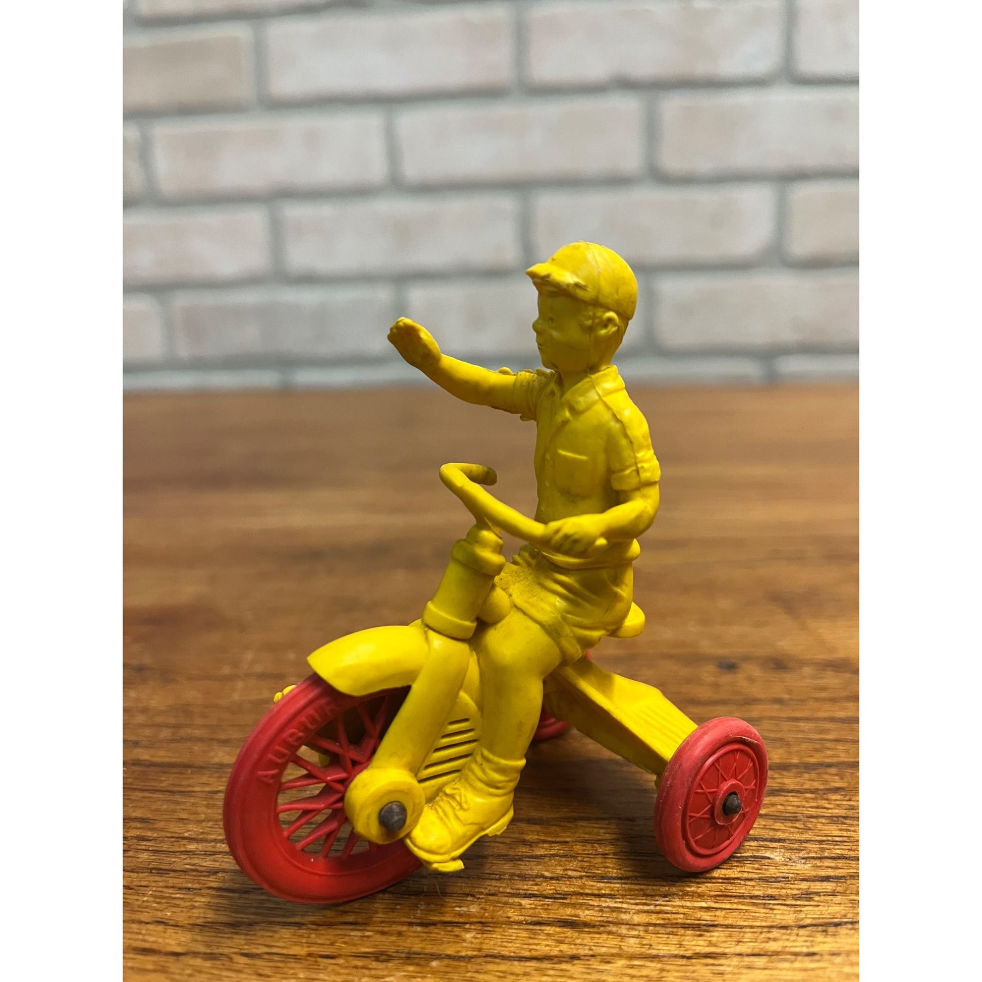 Vintage 1950s Auburn Rubber Co. Boy on Tricycle Toy Yellow Red 3"