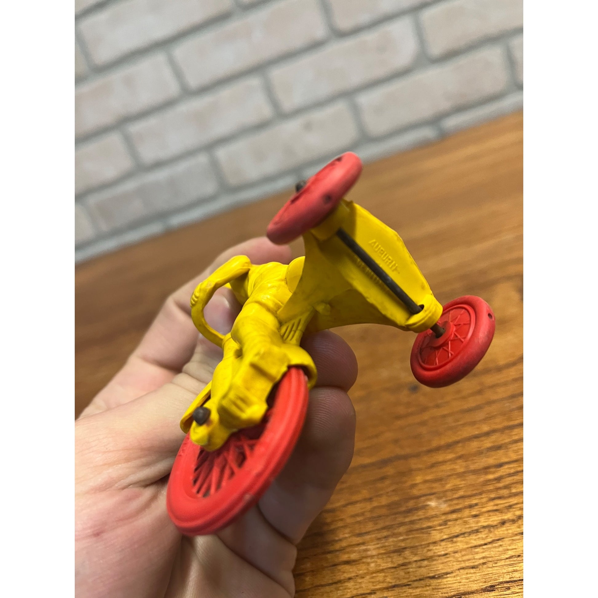 Vintage 1950s Auburn Rubber Co. Boy on Tricycle Toy Yellow Red 3"
