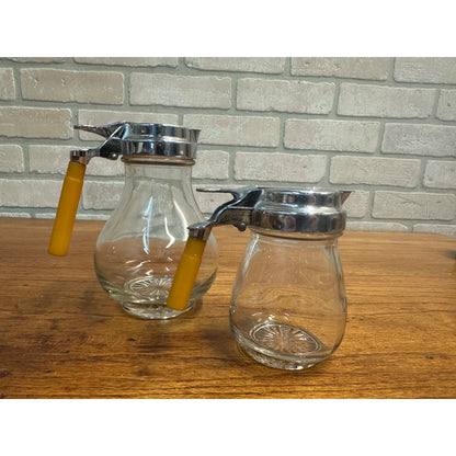 Vintage Pair Glass Syrup Pitchers Jars w/ Butterscotch Bakelite Handles