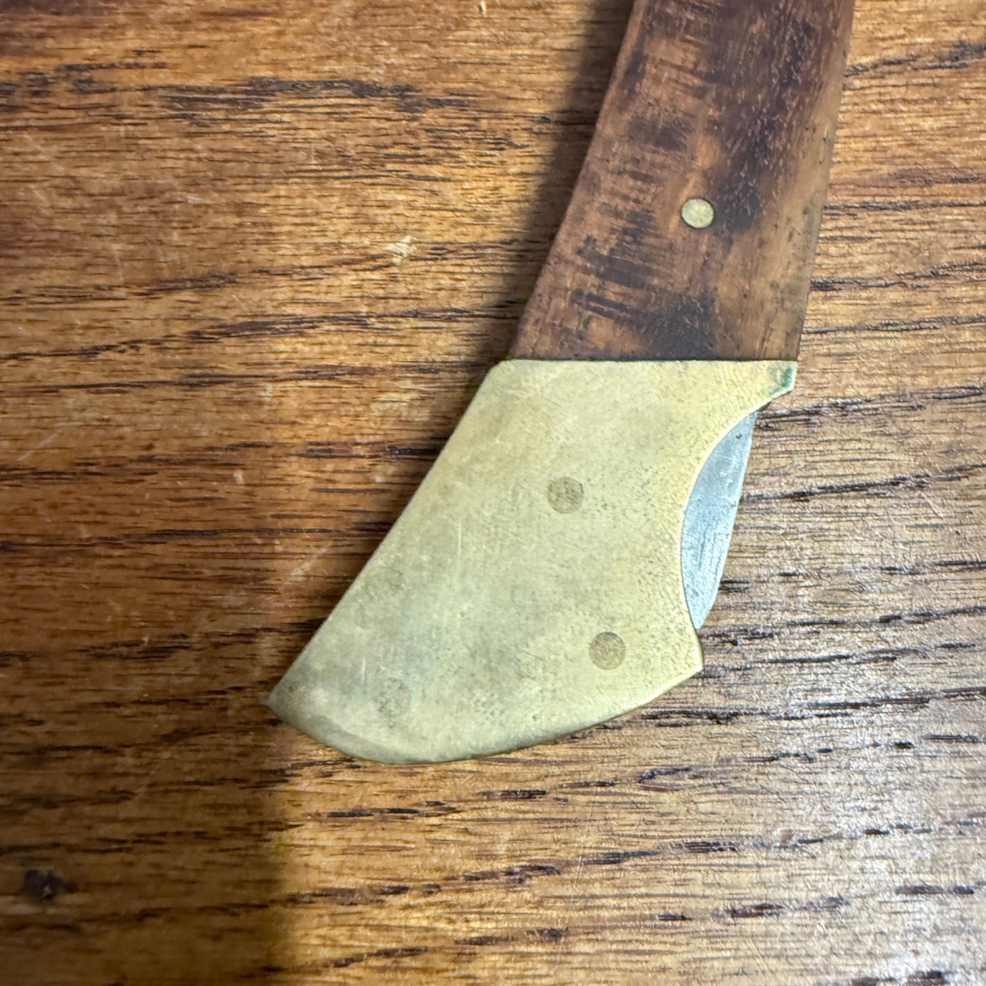 Vintage Stainless Steel Folding Knife With Brass-Accented Wooden Handle and Black Leather Sheath