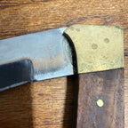 Vintage Stainless Steel Folding Knife With Brass-Accented Wooden Handle and Black Leather Sheath