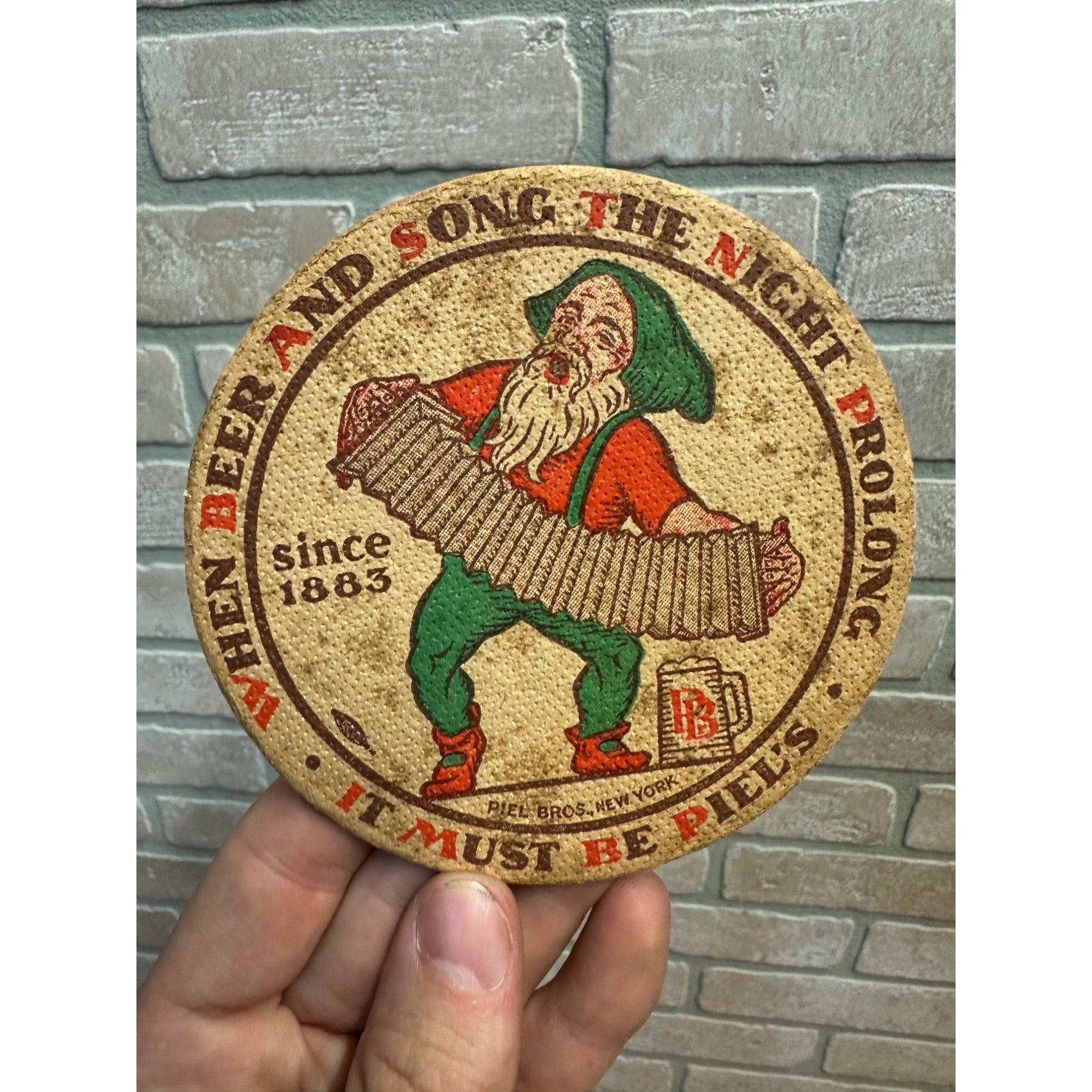 Piel’s Beer Coaster 4 Inch New York City Gnome Elf Accordion 1930’s