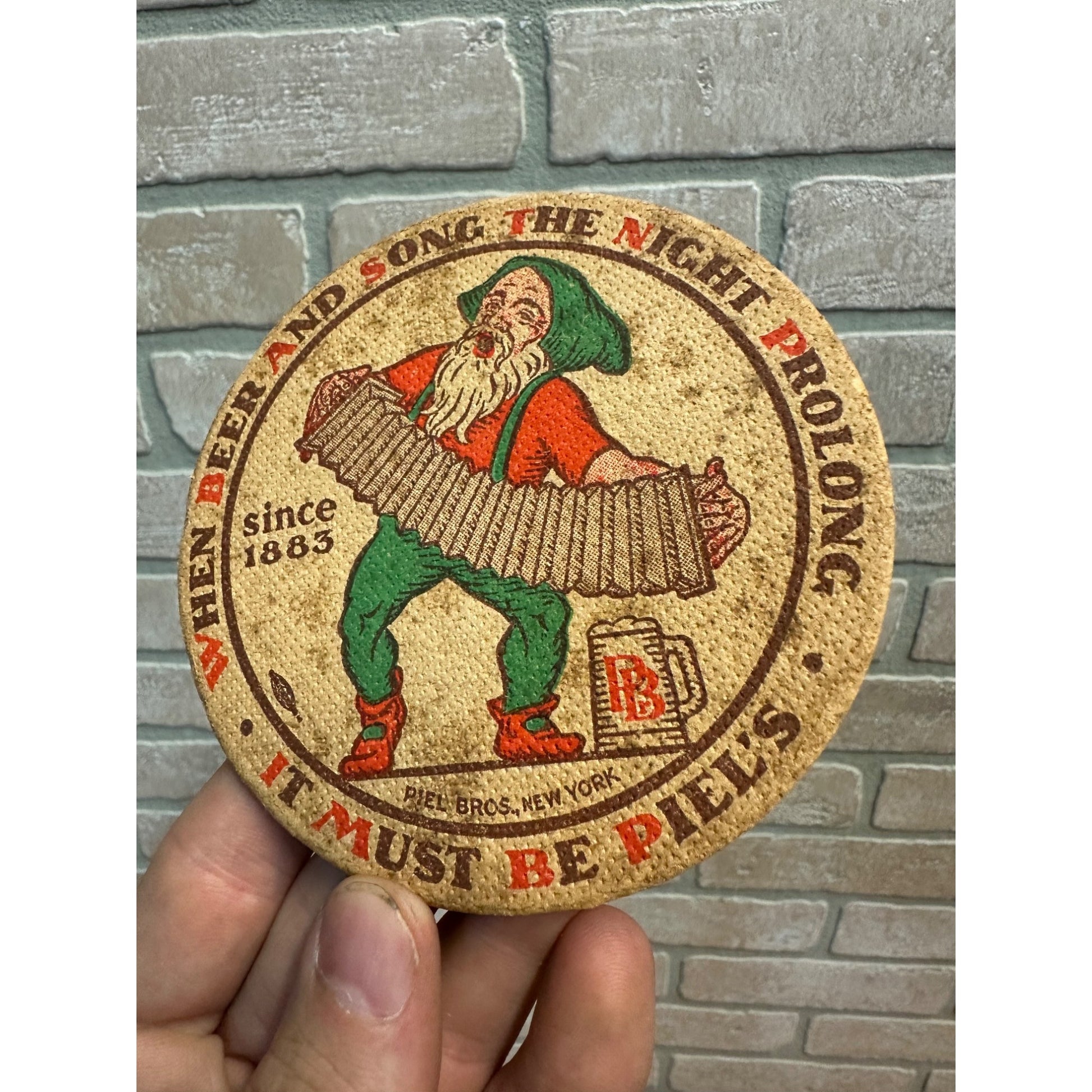 Piel’s Beer Coaster 4 Inch New York City Gnome Elf Accordion 1930’s